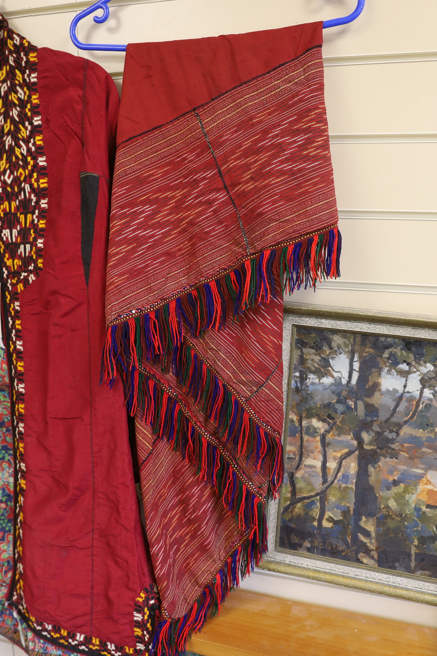 A Tekke Turkoman woman's red ground robe (khalat), the collar embroidered with red, gold and white devices, together with a red triangular shawl, longest side (2)